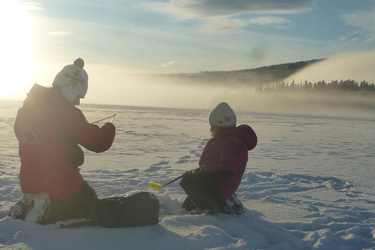 Ice fishing, popular family winter activity in Norway | Beito Husky Tours